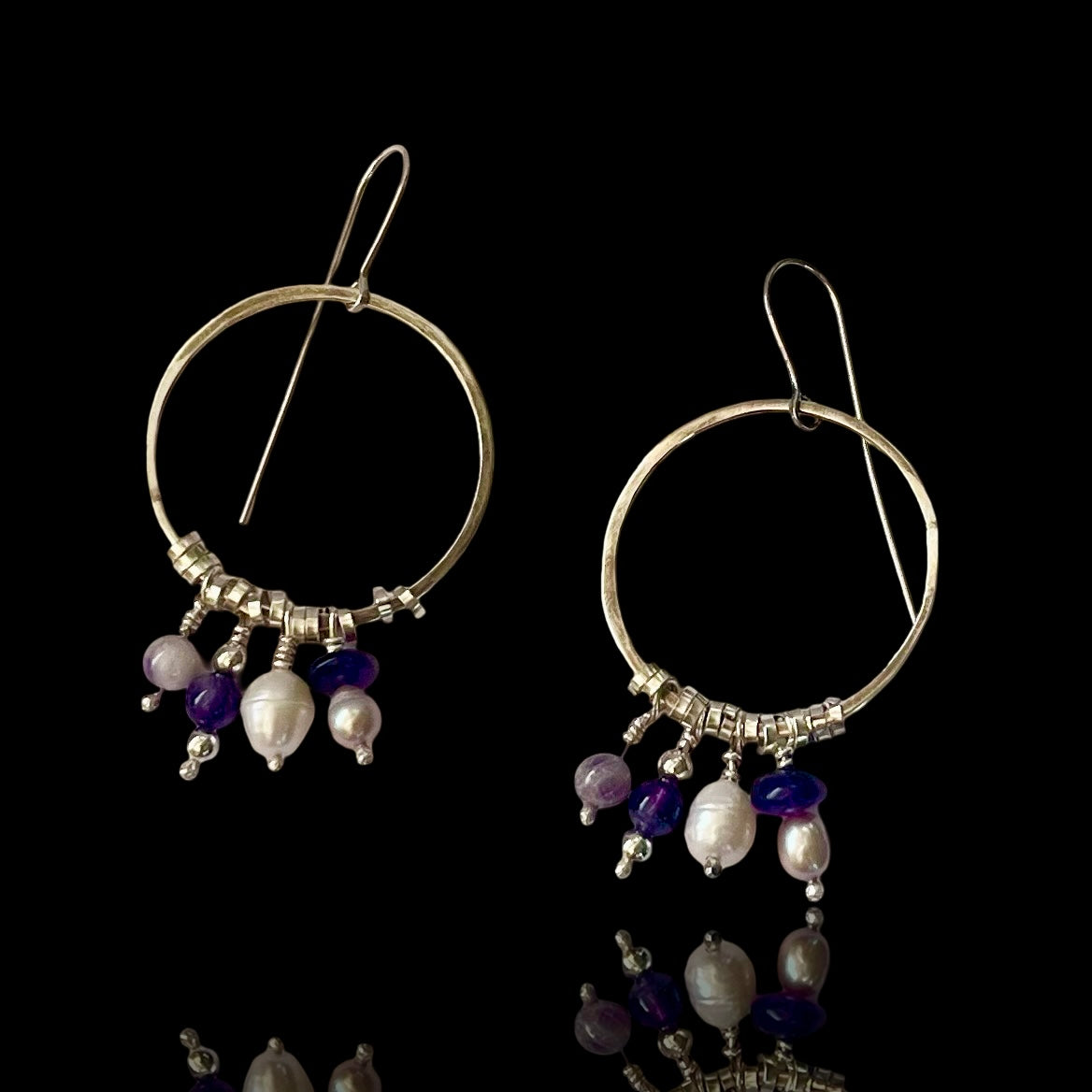 Boho silver hoops with dangling beads of amethyst and pearl, and small silvver rings. Very fun and swingy.