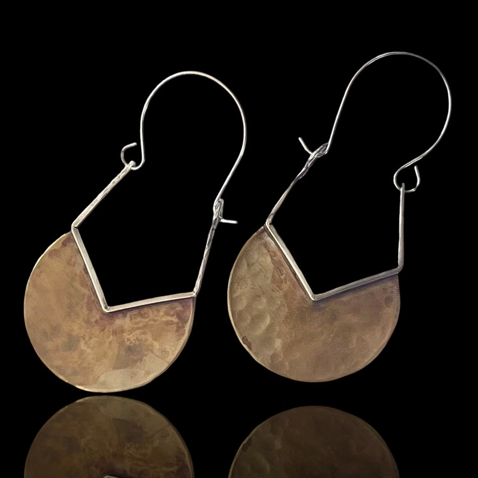 Hammered brass almost half circles with v-shaped cut trimmed in silver with an upside-down pentagon.  Sterling silver earwire completes this side dangling earring.  Very clean and attractive design.