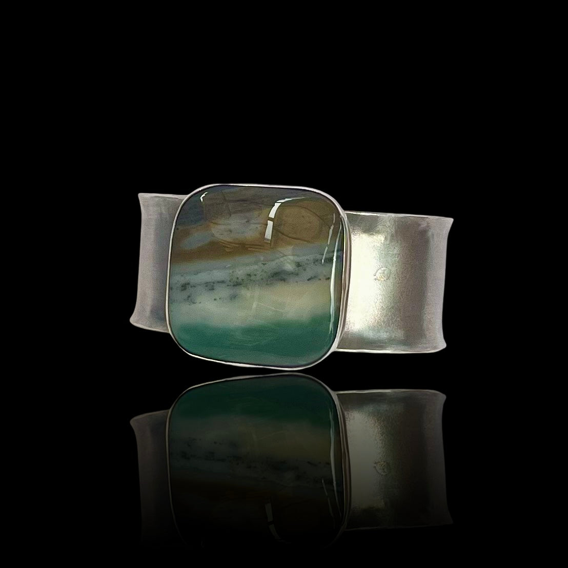 A slightly reticulated sterline cuff with a large square ocean wave jasper.